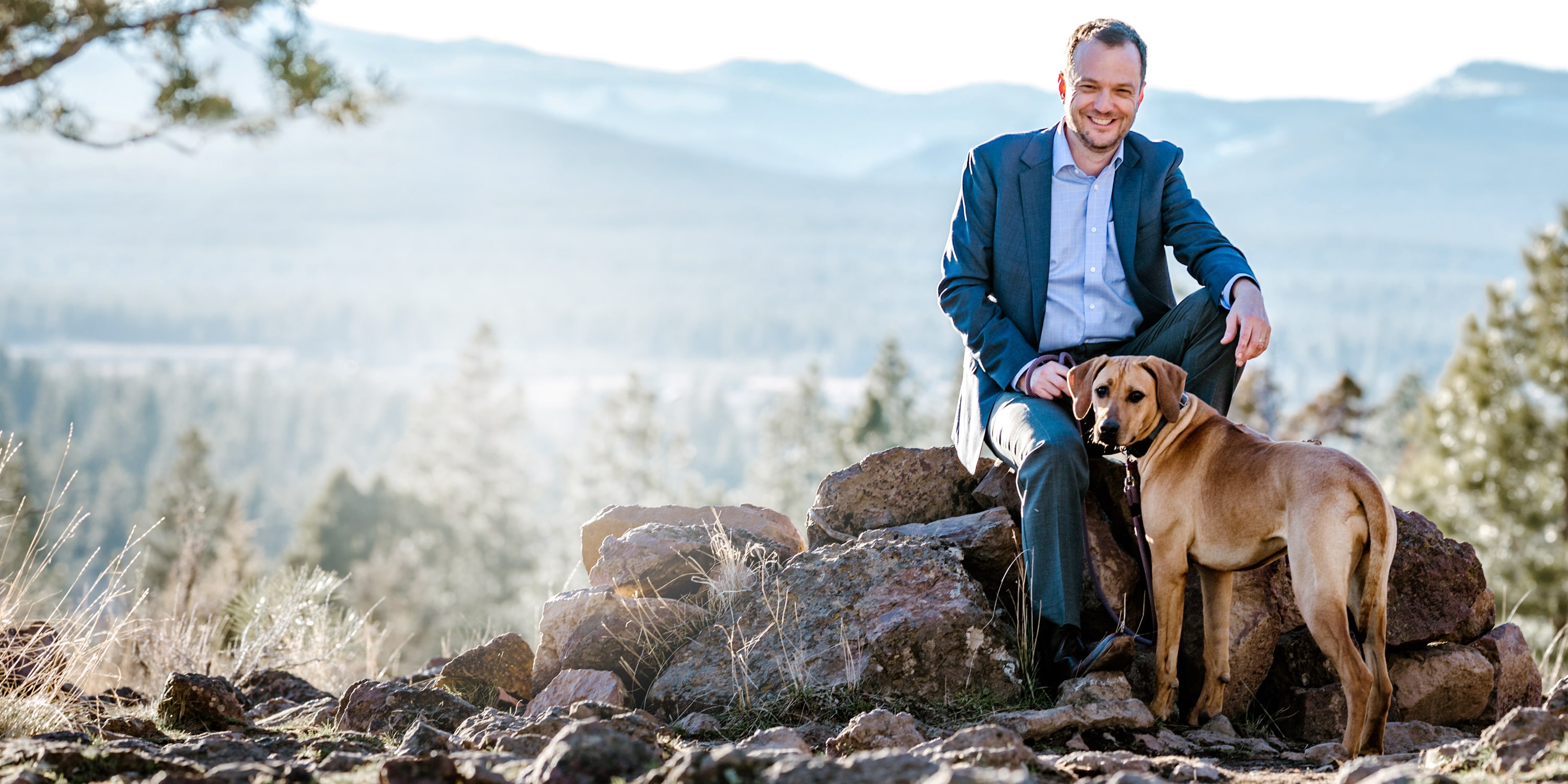 fp main image of cobin soelberg founder of greeley wealth management sitting with his dog
