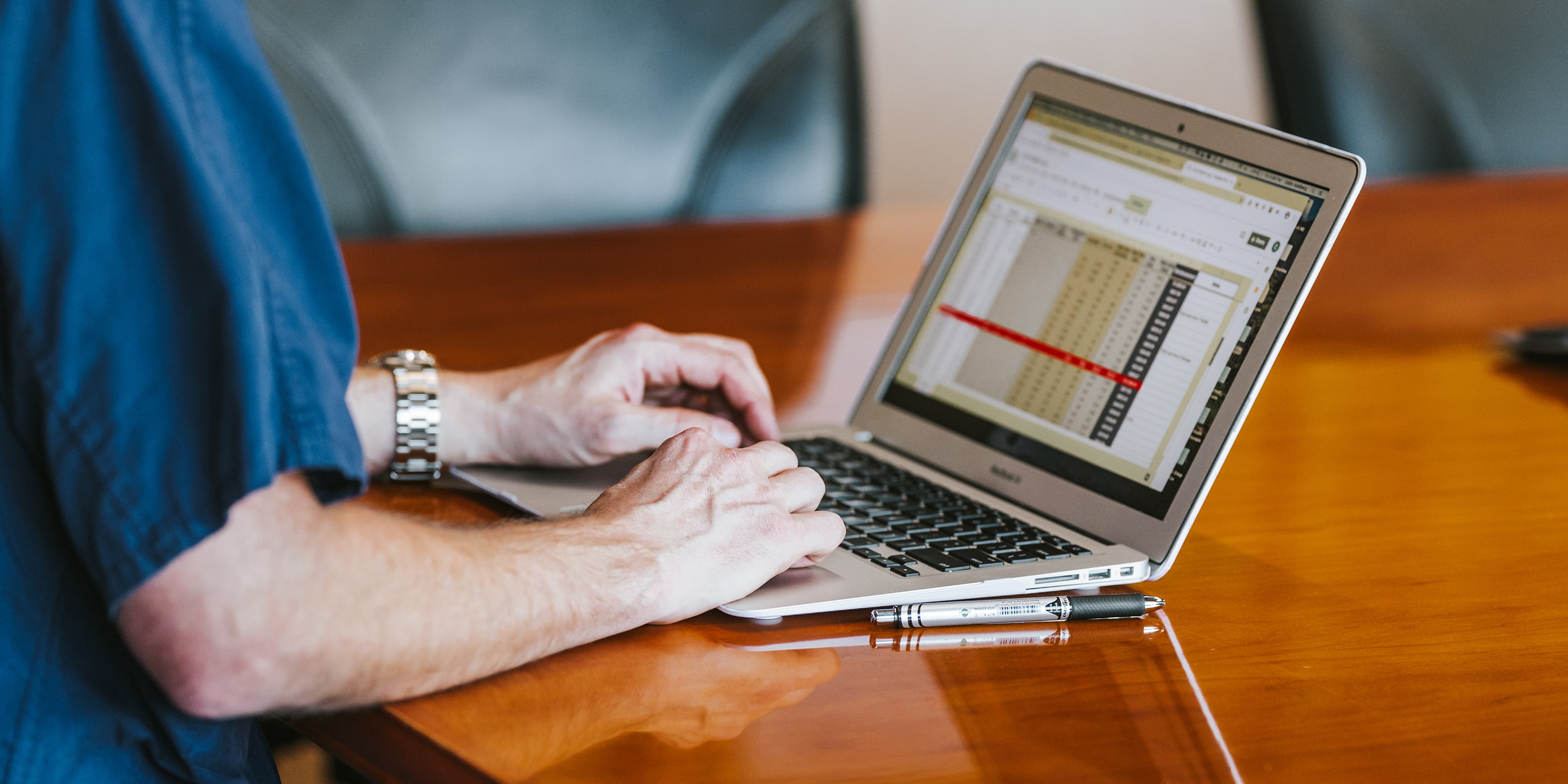 greeley wealth management privacy featured image of working on laptop at deskmg